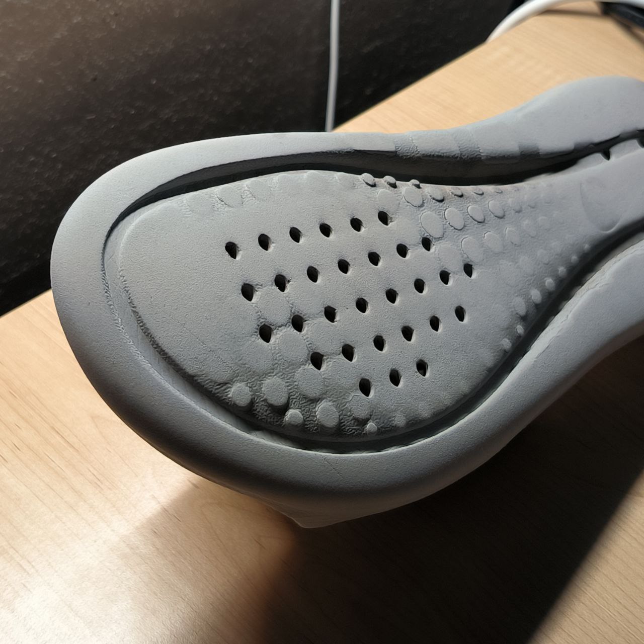 A close-up of the slippers insole reveals its texture and grip points—these details can help with placing sensors or conductive zones without interfering with comfort or use.